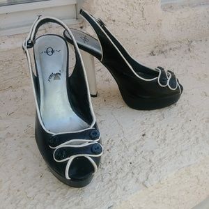 A pair of black and white womens heels